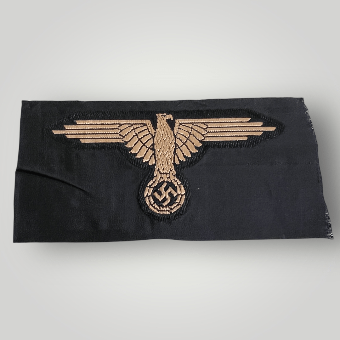 A German Waffen-SS Tropical BeVo Sleeve Badge, flat wire BeVo construction in tan coloured thread on a black background.