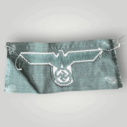 Reverse image of n original German WW2 Heer (Army) M38 Bevo breast eagle, flat weave BeVo construction on field green backing.