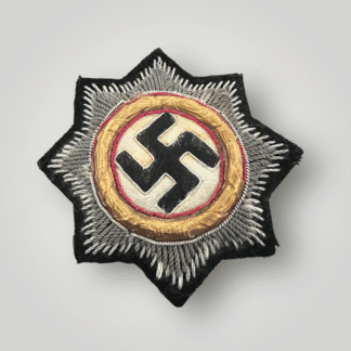 An original German Cross In Gold for panzer troops, hand embroidered example featuring a double starburst pattern with eight points on black wool backing.