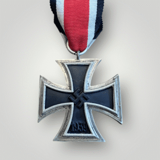 This is an original German WW2 Iron Cross 1939 2nd Class by Juncker. The medal features a three-part construction with magnetic iron core and retains its factory-applied paint finish, with  "crunch bead" and bright silver frame.