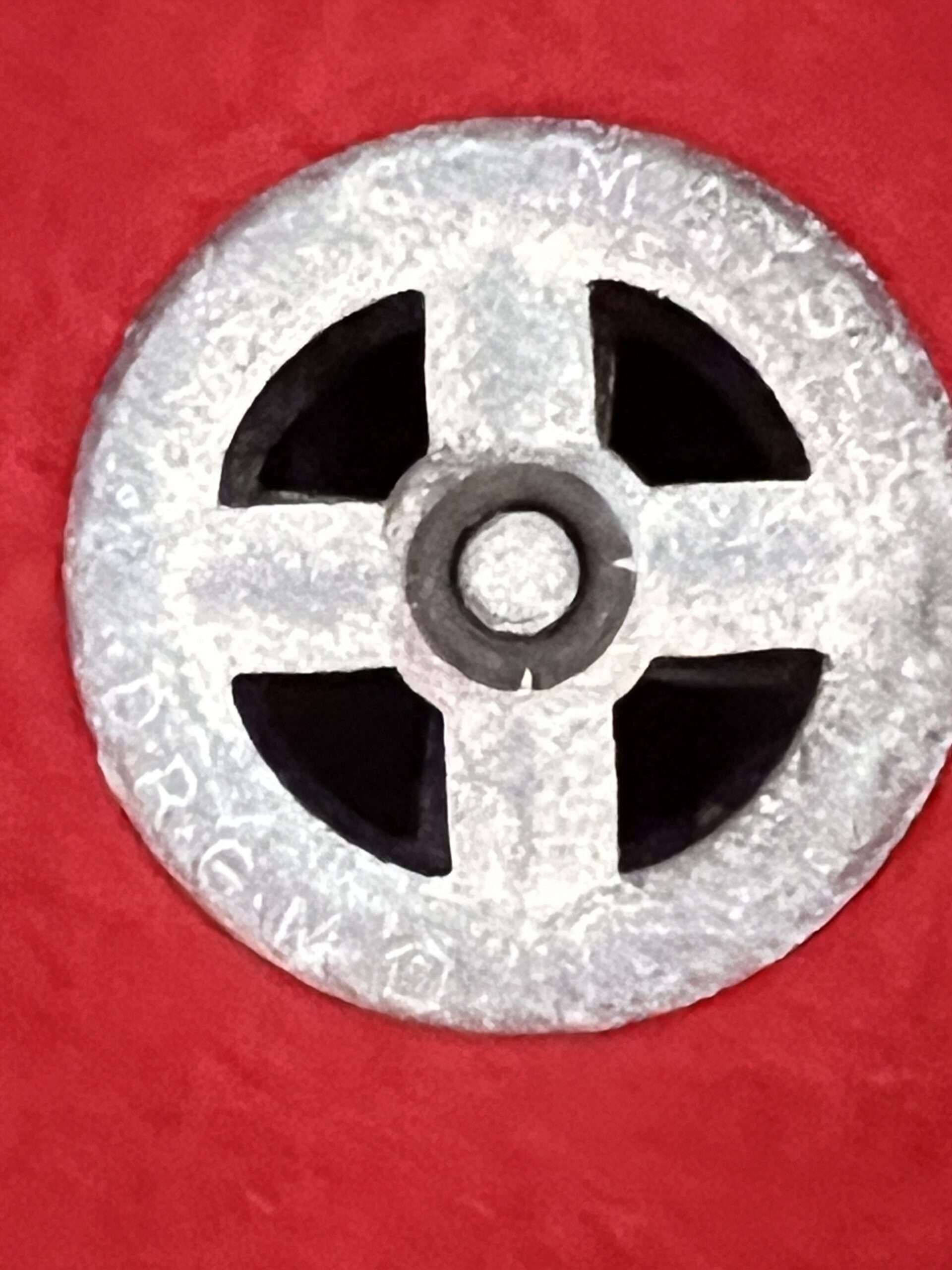 A photo of a zinc gromet for a Heer Afrikakorp Pith Helmet 2nd Pattern.