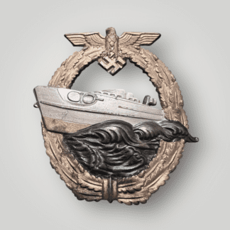 An original late war Kriegsmarine E-boat Badge by Adolf Scholz 2nd Pattern, constructed in zinc. The obverse of the badge retains has most of the gilt finish, around the wreath and the  hull of the boat has a nice finish as it cuts through the waves.