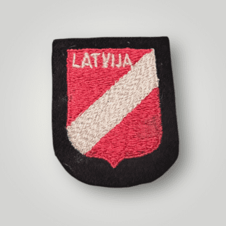 An original Waffen SS Latvia volunteer sleeve shield, machine embroidered in red and white thread on black wool backing.