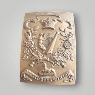 An original Victorian 18th Royal Irish Regiment cross belt plate buckle, die stamped in brass. The obverse of the buckle depicts a rectangular brass buckle embossed with a Celtic Harp in the centre flanked by floral garlands of rosses, shamrocks and thistles with an Egyptian sphinx below and scroll with the inscription “XVIII ROYAL IRISH" (18th Royal Irish).