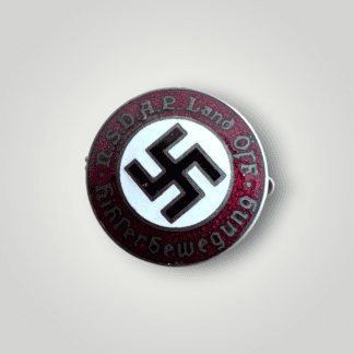 A very early Austrian NSDAP Hitlerbewegung party membership badge, constructed in red, white, black, and gold enamel. The obverse of the NSDAP pin has nice enamelwork with the lettering "NSDAP Land Öst."Hitlerbewegun" (NSDAP Country Eastern, Hitler Movement).