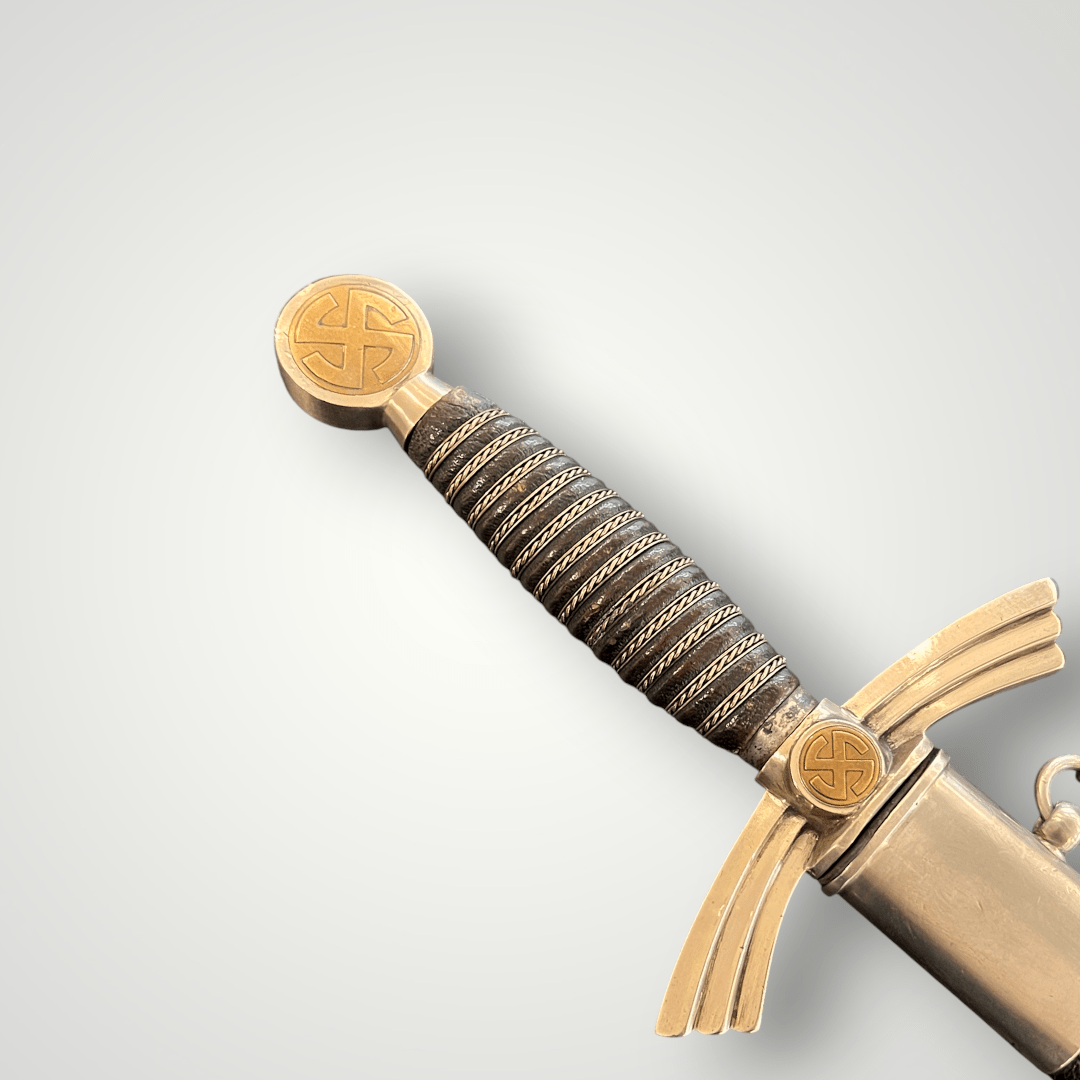 A photo of a Luftwaffe Dress Dagger 1st Model by Hörster Solingen, cross guard with brass sun beam swastika.