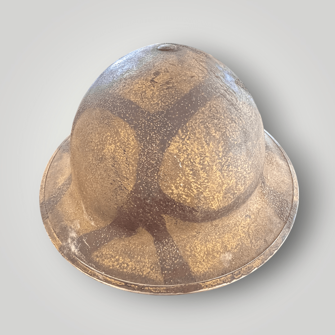A rare British WW2 MKII Helmet Malta camouflage, dated 1939. The exterior of the helmet is hand painted with the iconic Maltese camouflage pattern to blend in with the terrain.
