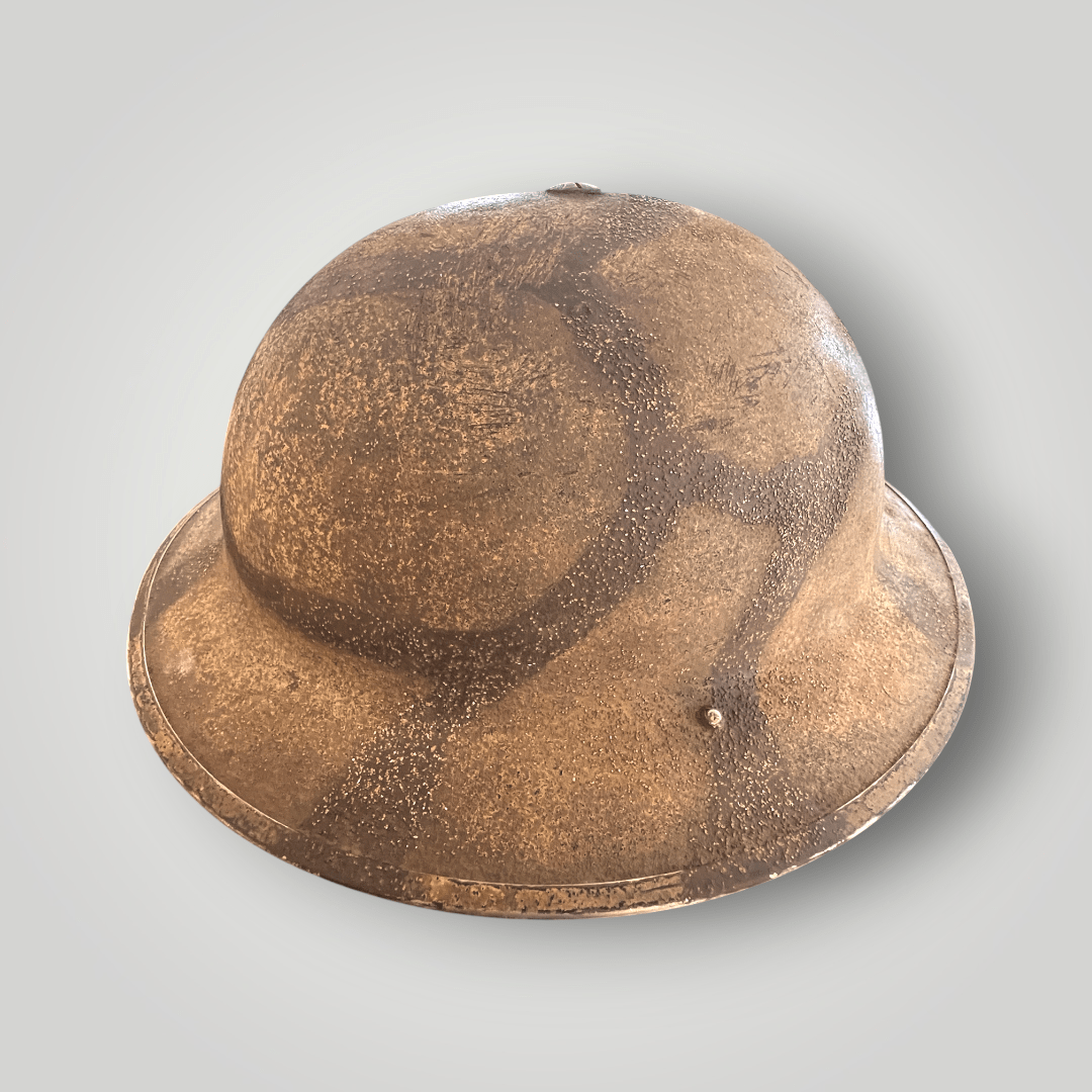 A rare British WW2 MKII Helmet Malta camouflage, dated 1939. The exterior of the helmet is hand painted with the iconic Maltese camouflage pattern to blend in with the terrain.