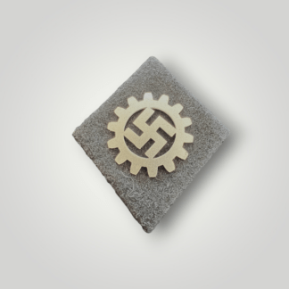 An orginal German WW2 DAF sleeve badge with RZM label (Deutsche Arbeitsfront), constructed in black woollen backing, with a aluminium DAF symbol in the centre (cogwheel and swastika).