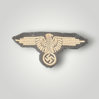 An original Waffen-SS cloth sleeve eagle for enlisted men, machine embroidered with silver-grey thread on black woollen backing.