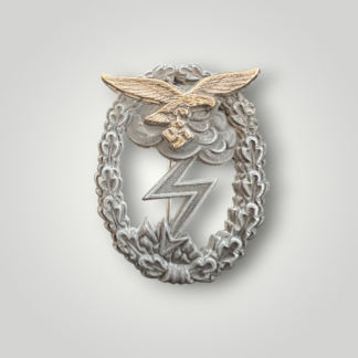 An original German WW2 Luftwaffe Ground Assault Badge by J.E.Hammer & Söhne, die-stamped two-part construction with the eagle in tombak and the oak wreath base in zink.