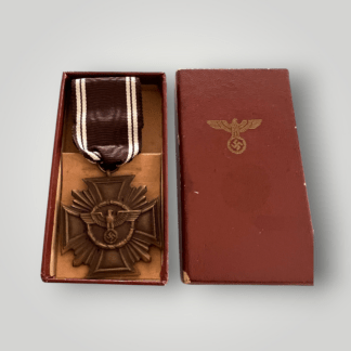 An original NSDAP Long Service Medal 10 Years with presentation box, constructed in zinc with original ribbon. The obverse of the medal has a beautiful bronze finish with nice patina, and the suspension ring is unmarked.