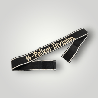 A desirable Waffen-SS Polizei Division cuff title, machine embroidered in black material with a flat-wire aluminium border. The cuff title is embroidered with the inscription “SS-Polizei-Division” in silver-grey thread. Both ends have been folded back and stitched with no damage or repairs in good condition.
