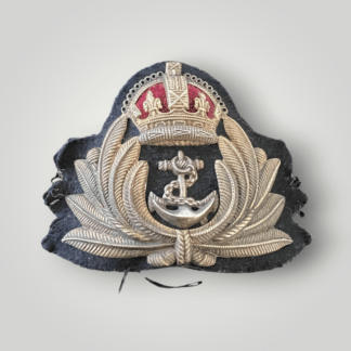 An original British WW2 Royal Navy Officers Gilt Cap Badge by J.R. Gaunt, constructed in brass and white and felt backing. The badge depicts a silver anchor, with a wrapped cable, surrounded by gold laurel leaves surmounted with a padded King's crown in red velvet.