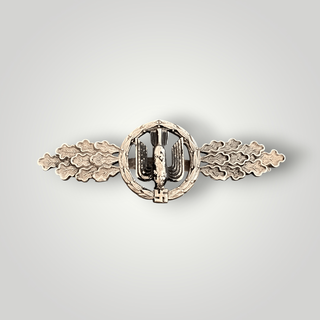 An original Luftwaffe Bombers Clasp in Silver by F&BL, constructed in zinc. The obverse of the decoration retains its original silver finish around the wreath and oak leaves, while the black paint on the bomber emblem shows light wear.