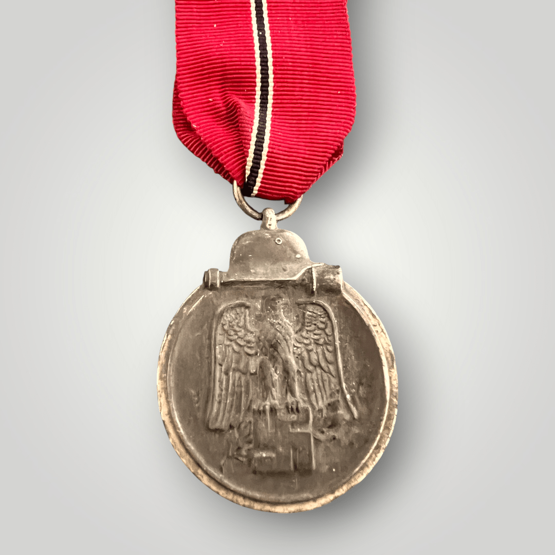 An genuine German WW2 Eastern Front Medal unknown maker, constructed in zinc. The suspension ring unmarked complete with the original ribbon in good condition.