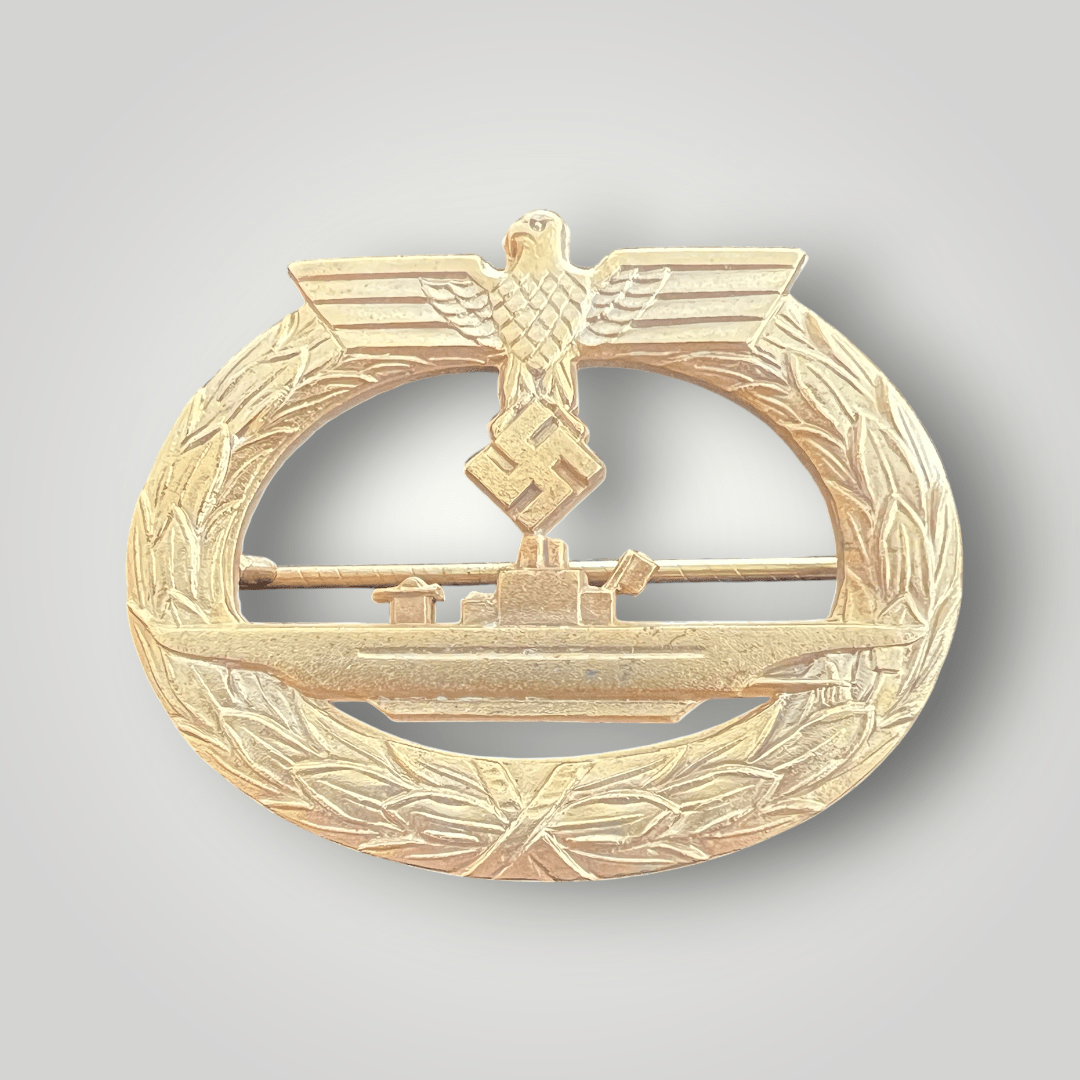 An original late war Kriegsmarine U-boat badge by Friedrich Orth, constructed in zinc which retain its gilt finish. The reverse of the badge is stamped with the makers mark 'FO' for Friedrich Orth, Wein complete with a horizontal soldered barrel hinge and catch.