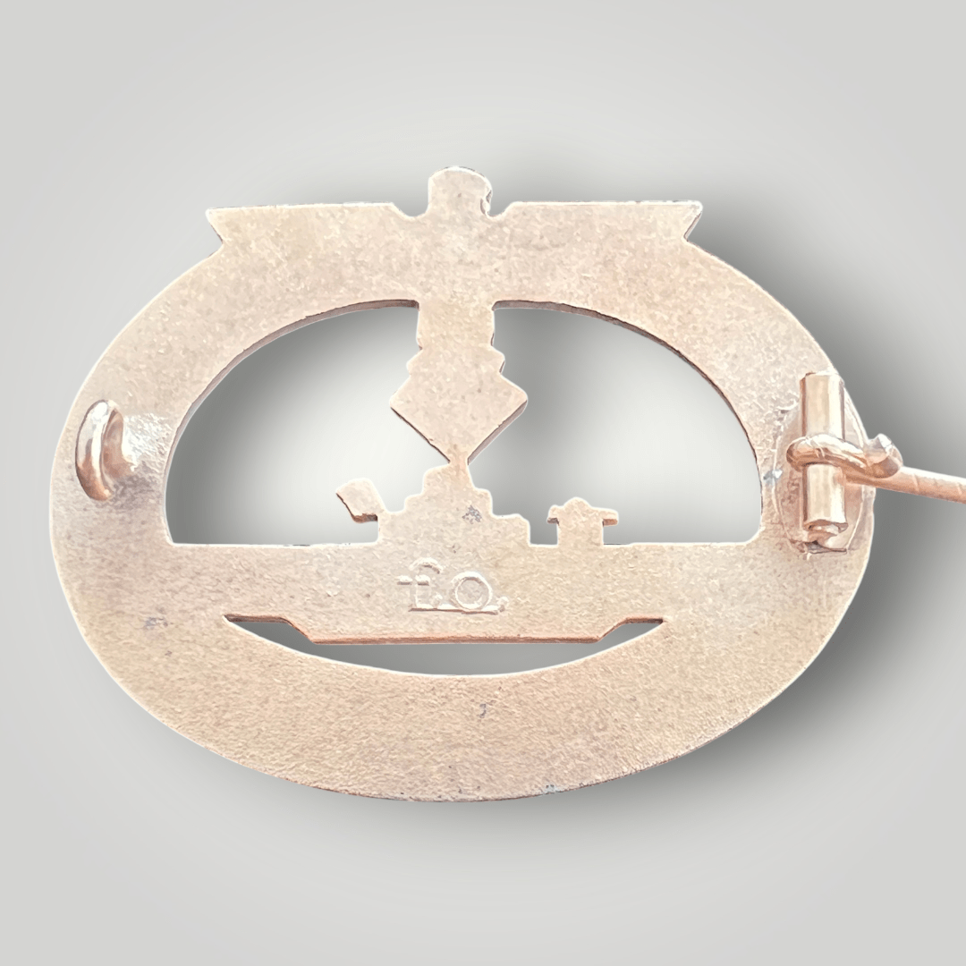 Reverse image of an original late war Kriegsmarine U-boat badge by Friedrich Orth, constructed in zinc. The reverse of the badge is stamped with the makers mark 'FO' for Friedrich Orth, Wein complete with a horizontal soldered barrel hinge and catch.