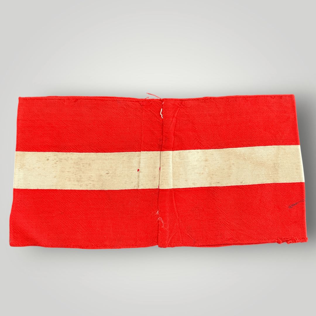 Reverse image of a genuine Hitler Youth cloth armband, constructed in red cotton.
