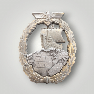 A Kriegsmarine Auxiliary Cruiser War Badge by Schwerin Berlin. Two part contstruction in zink with gilt finish.