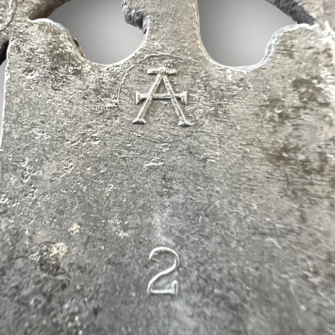 An original General Assault Badge by Assmann, constructed in zinc using a process called liquid-mold casting. The badge features an oval oak leaf wreath with acorns, with a German national eagle facing right, clutching a swastika, positioned above a crossed bayonet and a stick hand grenade.