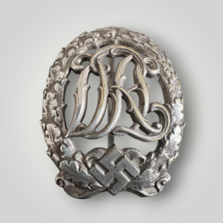 An original German DRL Sports Badge Silver, constructed of silvered bronze. The obverse consists of "DRL' script superimposed in the centre surrounded by an oak wreath with a swastika and bow below. 
