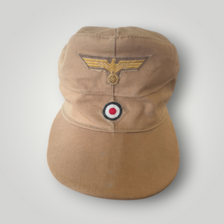 An original Kriegsmarine M41 tropical field cap by Franz Ritter for enlisted men and NCOs. Constructed from ribbed khaki cotton, complete with machine applied insignia.