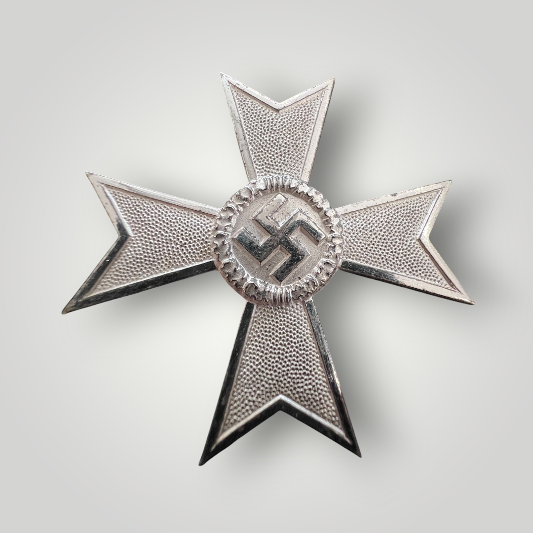 An original War Merit Cross, 1st Class without Swords by Foerster & Barth, constructed in silvered tombac. The obverse features a Maltese cross with a central swastika, encircled by oak leaves.