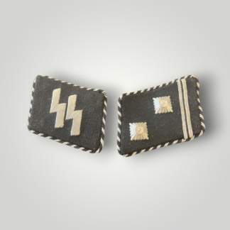 A rare, early matching set of SS Leibstandarte Adolf Hitler collar tabs for the rank of Hauptsturmführer. The tabs are constructed from fine black doeskin, edged with twisted silver-and-black braid and reinforced with buckram backing and silver bullion rank bars.