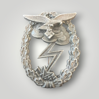 An original Luftwaffe Ground Assault Badge by Gustav Brehmer, constructed in zinc, late war, one-piece construction. The reverse of the decoration is unmarked, but attributed to Gustav Brehmer, Markneukirchen complete with barrel hinge and flat wire catch with vertical pin.